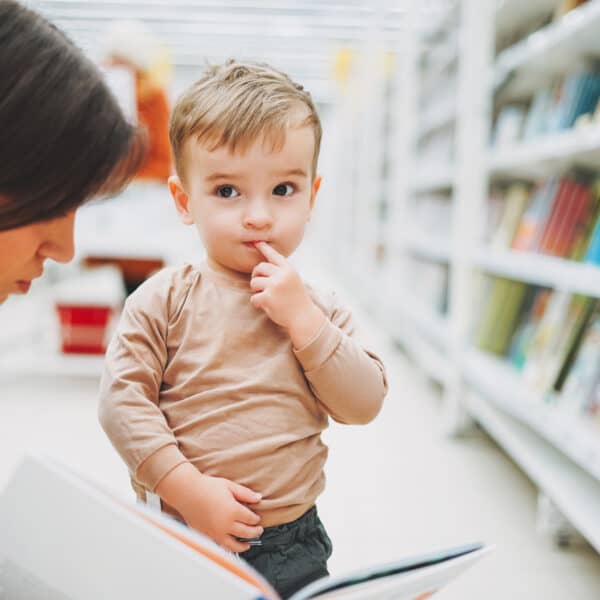 cute-baby-boy-toddler-child-in-bookstore-with-moth-QTZKFEJ